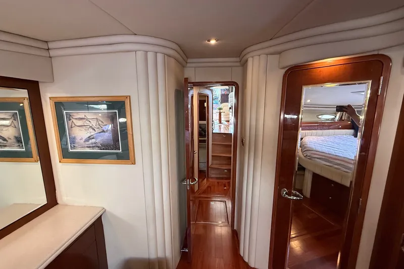 Slide: The Image of Interior of 2002 Sea Ray 560 Sedan Bridge yacht with wood finishes and framed artwork. - 97