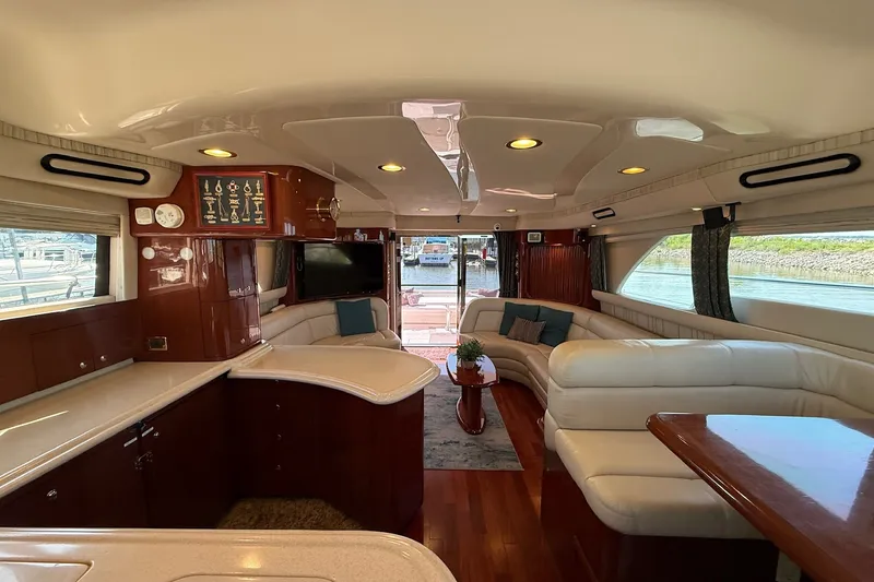 Slide: The Image of Luxurious interior of a 2002 Sea Ray 560 Sedan Bridge yacht with elegant seating and wood finishes. - 73