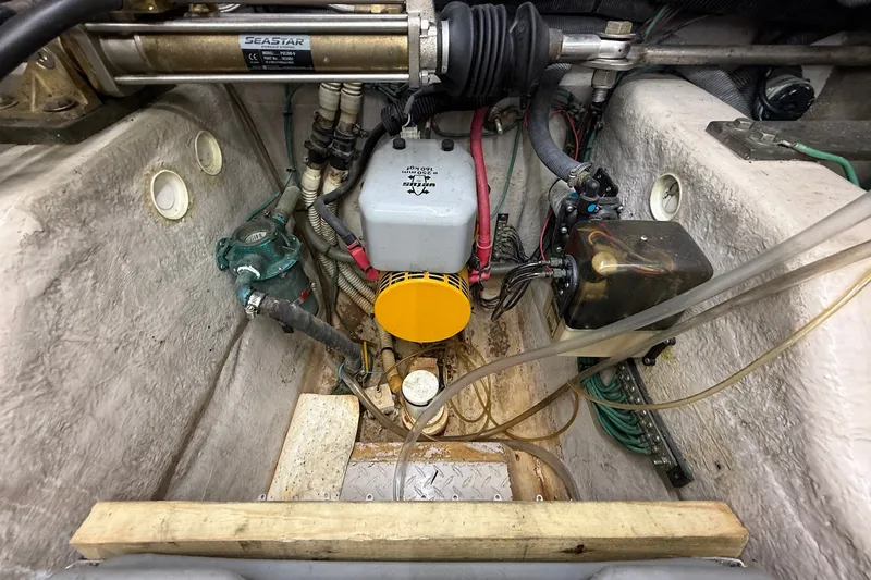 Slide: The Image of Engine compartment of a 2002 Sea Ray 560 Sedan Bridge with visible hydraulic components. - 133