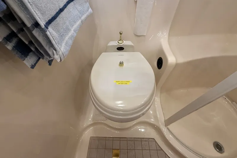 Slide: The Image of Bathroom in 2002 Sea Ray 560 Sedan Bridge yacht with toilet and shower. - 88