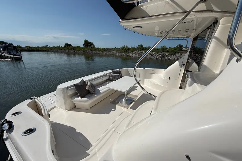 Slide: The Image of Luxurious 2002 Sea Ray 560 Sedan Bridge yacht with spacious deck and seating area. - 20