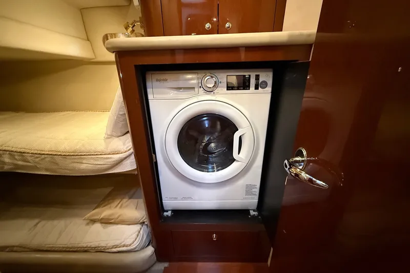 Slide: The Image of Laundry area with washer in 2002 Sea Ray 560 Sedan Bridge yacht cabin. - 80