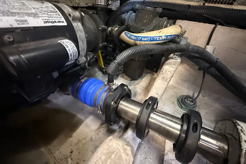 Slide: The Image of Engine compartment of a 2002 Sea Ray 560 Sedan Bridge, showing mechanical components and hoses. - 111