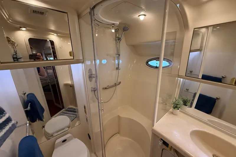 Slide: The Image of Luxurious bathroom in 2002 Sea Ray 560 Sedan Bridge yacht with shower and vanity. - 104