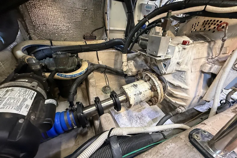Slide: The Image of Engine room of a 2002 Sea Ray 560 Sedan Bridge, showcasing mechanical components and wiring. - 110