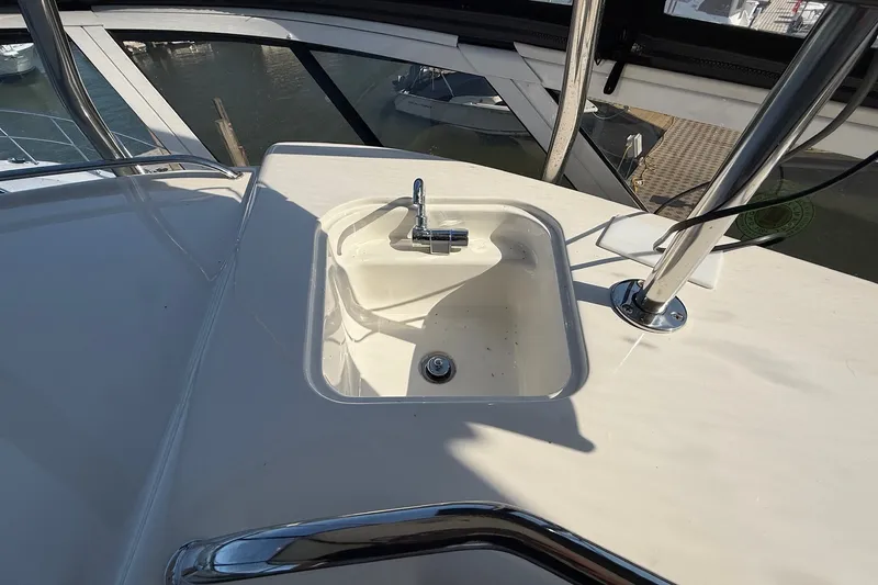 Slide: The Image of 2002 Sea Ray 560 Sedan Bridge yacht sink on deck, overlooking marina. - 31