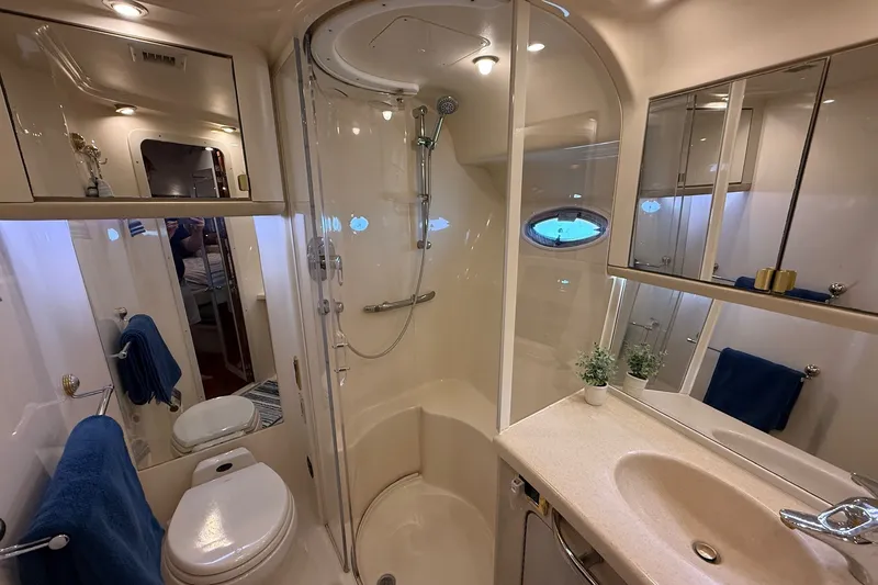 Slide: The Image of Luxurious bathroom in 2002 Sea Ray 560 Sedan Bridge yacht with shower and vanity. - 101