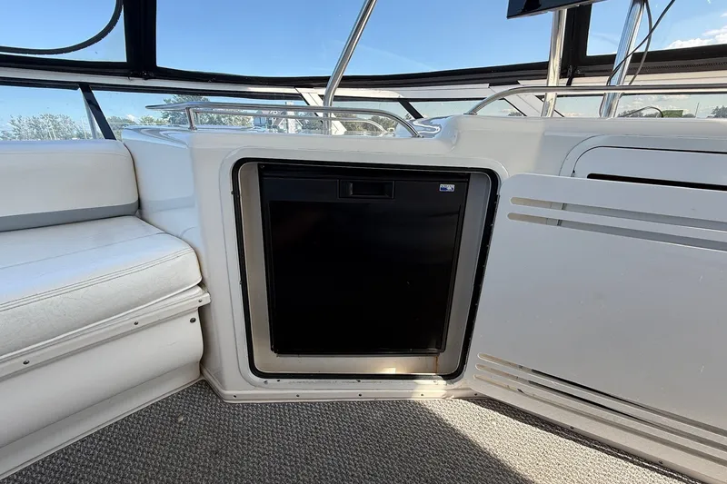 Slide: The Image of Interior of 2002 Sea Ray 560 Sedan Bridge with built-in mini fridge. - 29