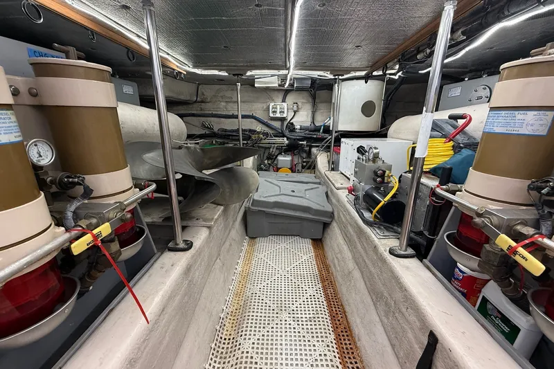 Slide: The Image of Engine room of a 2002 Sea Ray 560 Sedan Bridge with mechanical components and equipment. - 129