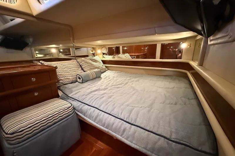 Slide: The Image of Luxurious cabin interior of 2002 Sea Ray 560 Sedan Bridge yacht with cozy bedding. - 85