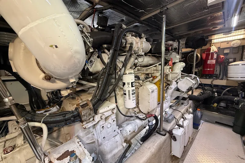 Slide: The Image of Engine room of a 2002 Sea Ray 560 Sedan Bridge yacht, showcasing complex machinery. - 114