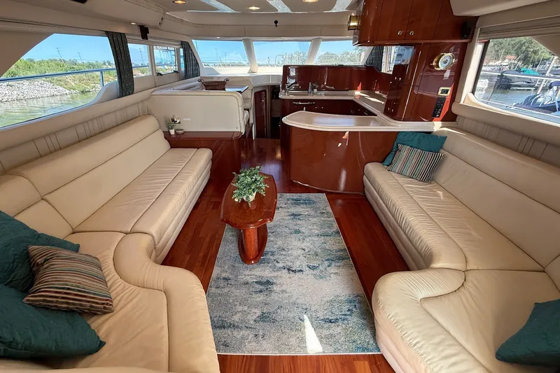 Slide: The Image of Luxurious interior of 2002 Sea Ray 560 Sedan Bridge yacht with elegant seating and wood finishes. - 50