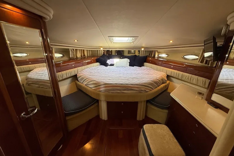 Slide: The Image of Luxurious cabin interior of 2002 Sea Ray 560 Sedan Bridge yacht with cozy bed and elegant wood finish. - 92