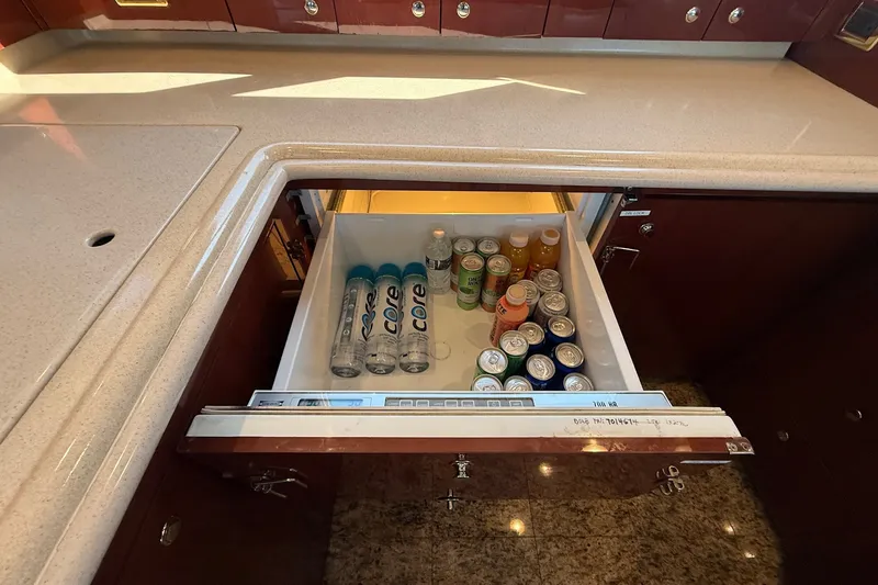 Slide: The Image of Built-in fridge drawer on 2002 Sea Ray 560 Sedan Bridge, stocked with beverages. - 71