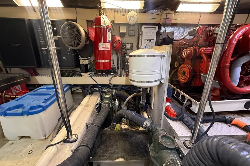 Slide: The Image of Engine room of a 2002 Sea Ray 560 Sedan Bridge with visible machinery and equipment. - 115