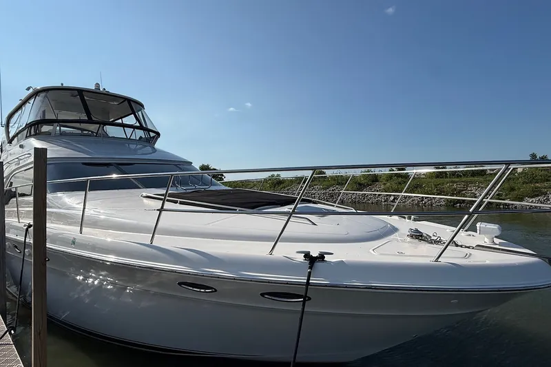 Slide: The Image of 2002 Sea Ray 560 Sedan Bridge yacht docked under clear blue sky. - 6