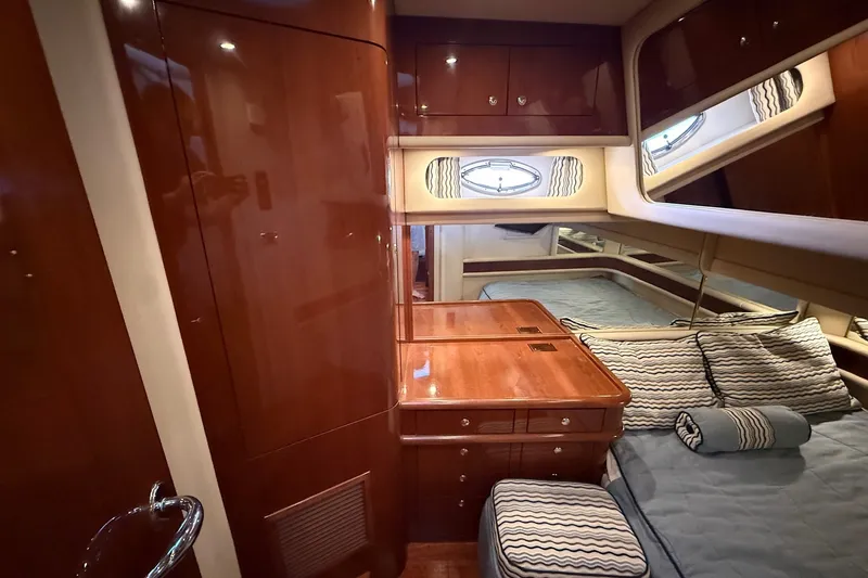 Slide: The Image of Luxurious 2002 Sea Ray 560 Sedan Bridge cabin with polished wood and elegant bedding. - 82