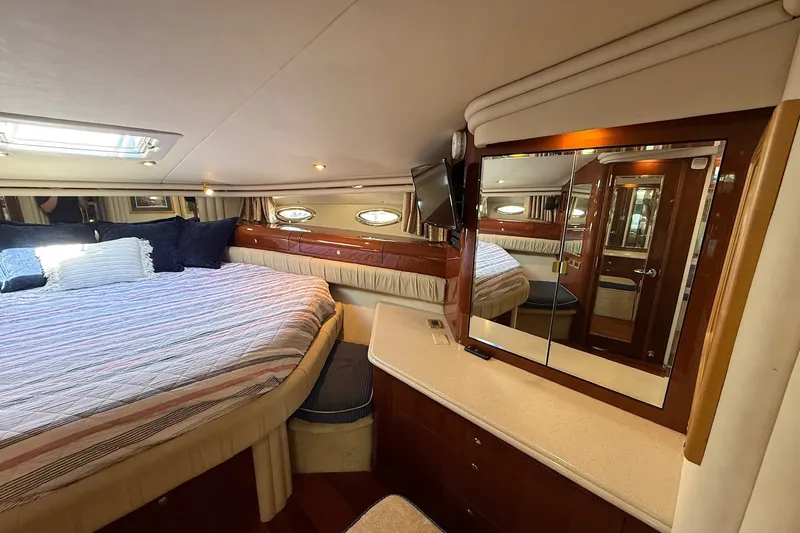 Slide: The Image of Luxurious 2002 Sea Ray 560 Sedan Bridge cabin with cozy bed and elegant wood finishes. - 93