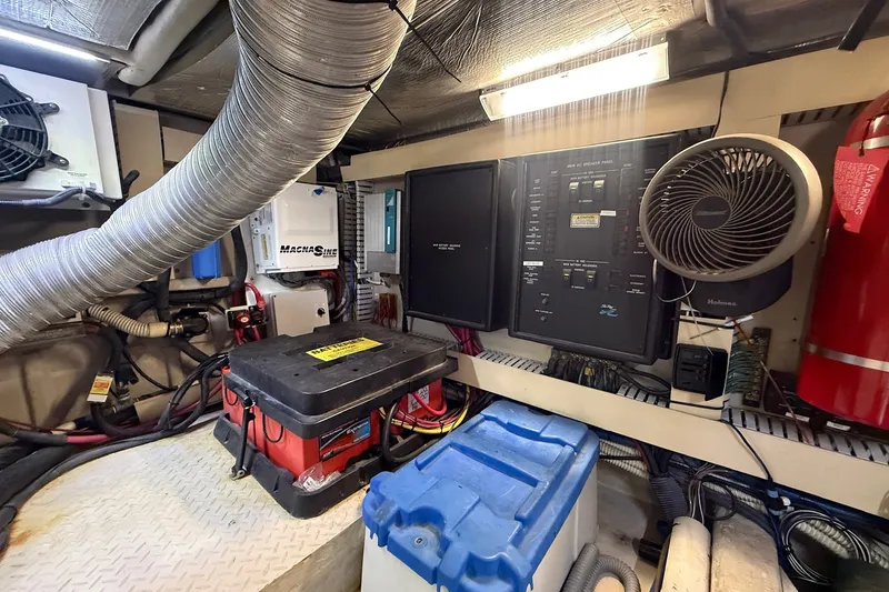 Slide: The Image of Engine room of 2002 Sea Ray 560 Sedan Bridge with electrical panels and equipment. - 116