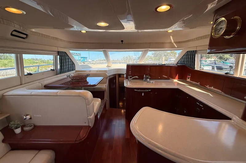 Slide: The Image of Luxurious interior of a 2002 Sea Ray 560 Sedan Bridge yacht with elegant wood finishes. - 63