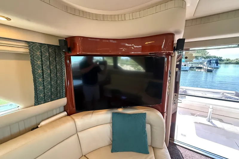 Slide: The Image of Luxurious interior of 2002 Sea Ray 560 Sedan Bridge with TV and waterfront view. - 54