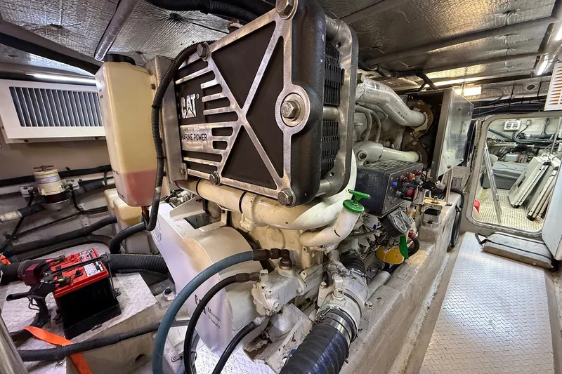 Slide: The Image of Engine room of a 2002 Sea Ray 560 Sedan Bridge, featuring a CAT marine engine. - 123