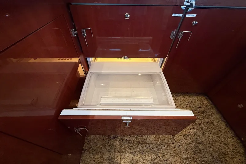Slide: The Image of Open storage compartment in 2002 Sea Ray 560 Sedan Bridge yacht interior. - 72