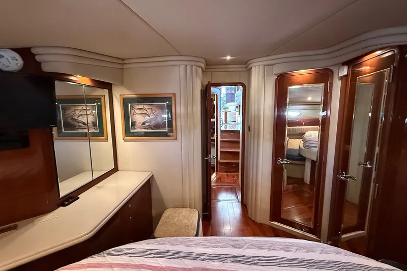 Slide: The Image of Luxurious interior of 2002 Sea Ray 560 Sedan Bridge yacht cabin with elegant wood finishes. - 99