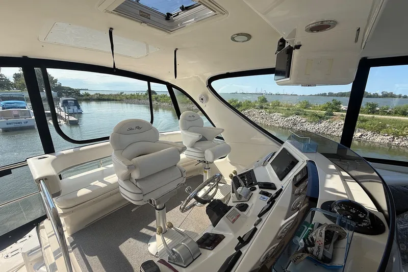 Slide: The Image of Interior of 2002 Sea Ray 560 Sedan Bridge yacht with helm and seating area. - 33