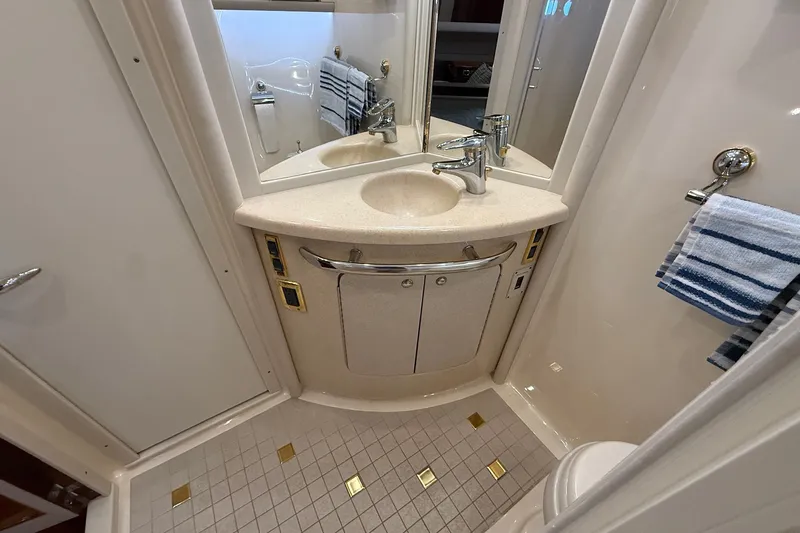 Slide: The Image of Bathroom interior of 2002 Sea Ray 560 Sedan Bridge yacht, featuring sink and mirror. - 91