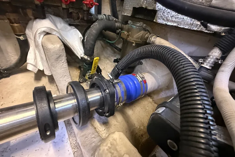 Slide: The Image of Engine room of 2002 Sea Ray 560 Sedan Bridge with visible hoses and fittings. - 112
