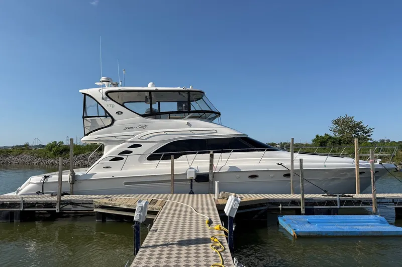 Slide: The Image of 2002 Sea Ray 560 Sedan Bridge yacht docked on a sunny day. - 3