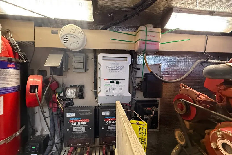 Slide: The Image of Engine room of 2002 Sea Ray 560 Sedan Bridge with electrical components and fire extinguisher. - 117