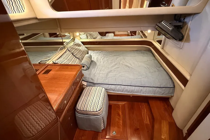 Slide: The Image of Luxurious cabin interior of 2002 Sea Ray 560 Sedan Bridge yacht with wood accents. - 86