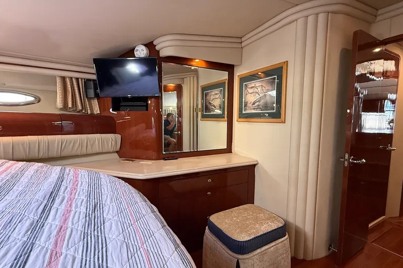 Slide: The Image of Luxurious interior of 2002 Sea Ray 560 Sedan Bridge yacht cabin with TV and vanity. - 96