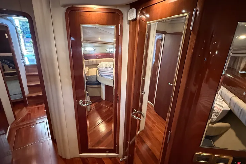 Slide: The Image of Luxurious interior of 2002 Sea Ray 560 Sedan Bridge yacht with polished wood finishes. - 100