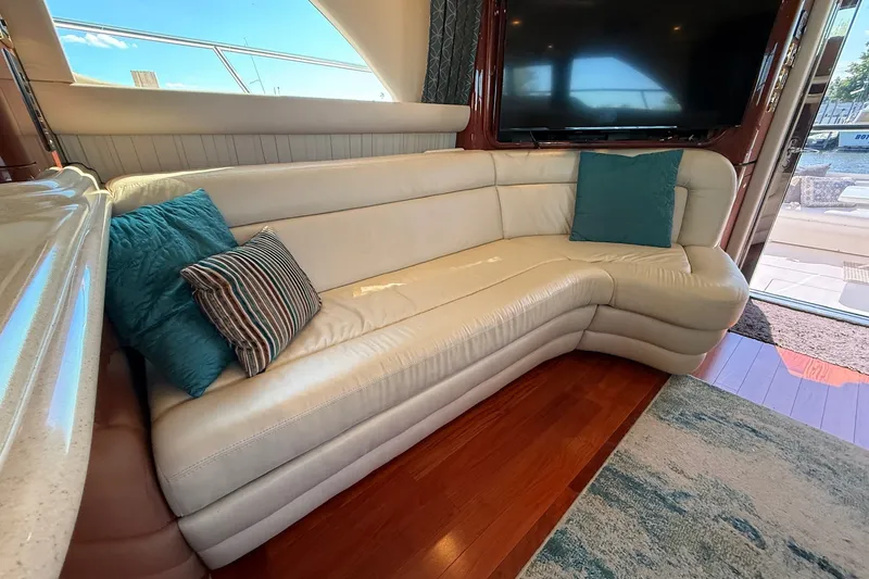 Slide: The Image of Luxurious interior of 2002 Sea Ray 560 Sedan Bridge with plush white leather seating. - 57