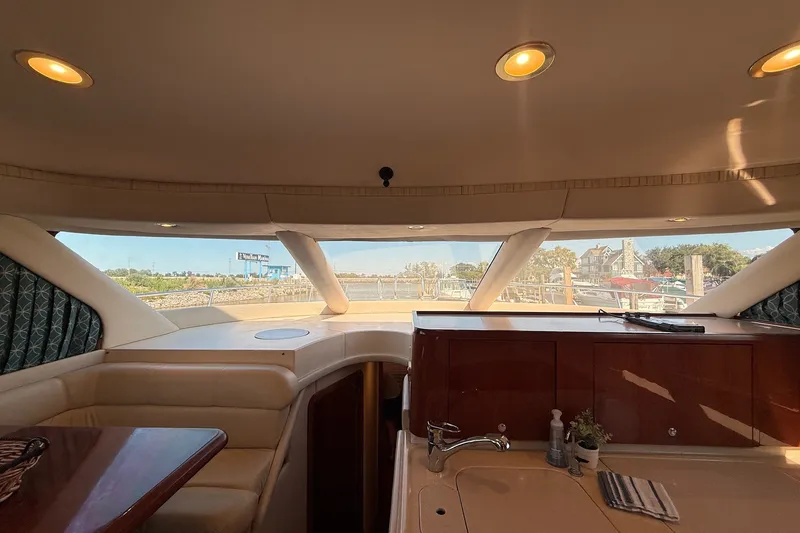 Slide: The Image of Interior view of 2002 Sea Ray 560 Sedan Bridge yacht with scenic marina backdrop. - 60