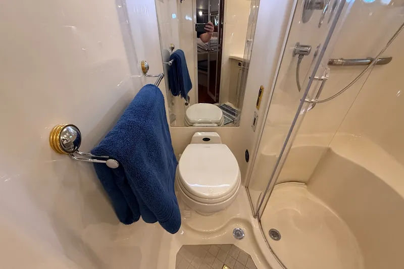 Slide: The Image of Bathroom interior of 2002 Sea Ray 560 Sedan Bridge yacht with shower and toilet. - 103