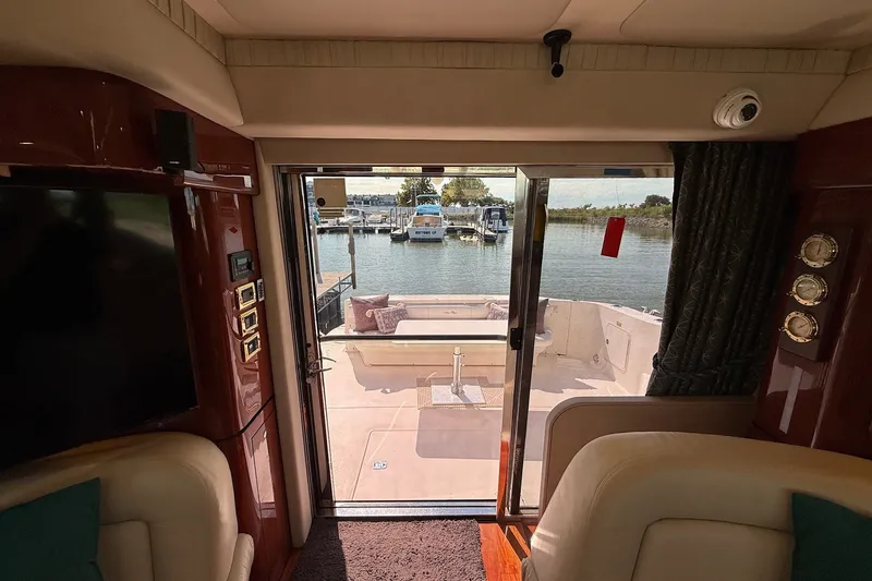 Slide: The Image of Interior view of 2002 Sea Ray 560 Sedan Bridge yacht with marina backdrop. - 74