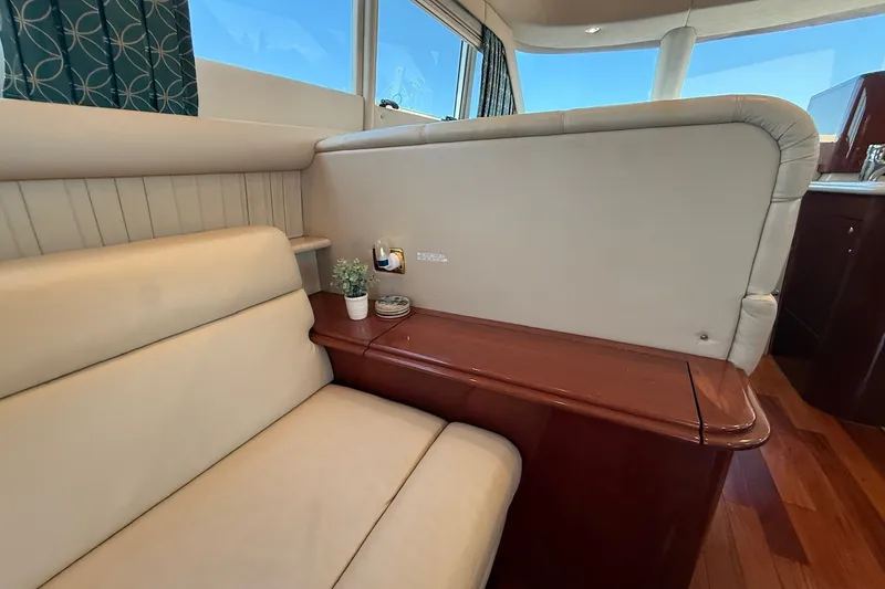 Slide: The Image of Luxurious interior of 2002 Sea Ray 560 Sedan Bridge yacht with beige seating. - 56