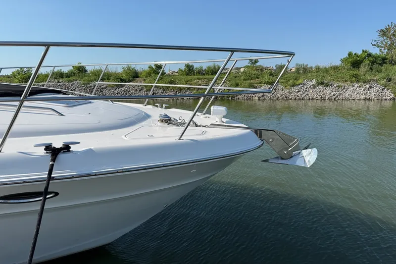 Slide: The Image of Bow of a 2002 Sea Ray 560 Sedan Bridge yacht anchored in calm waters. - 5