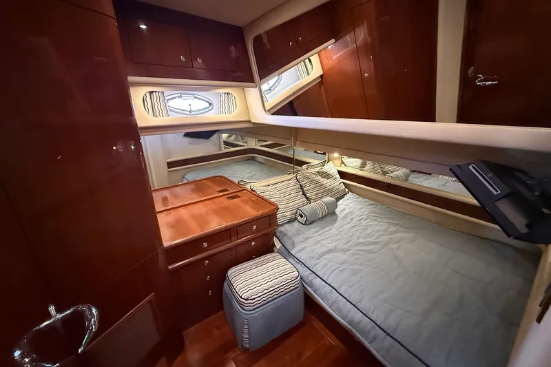 Slide: The Image of Luxurious cabin interior of 2002 Sea Ray 560 Sedan Bridge yacht, featuring elegant wood finishes. - 81