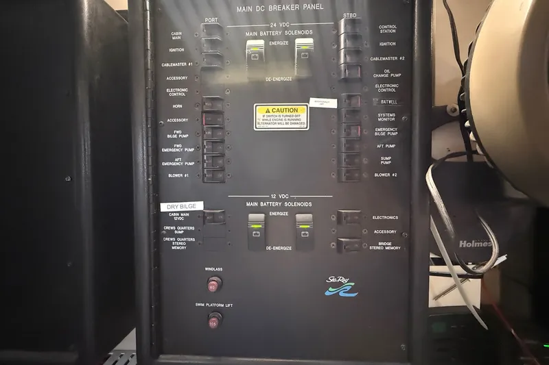 Slide: The Image of Main DC breaker panel of 2002 Sea Ray 560 Sedan Bridge yacht, featuring various switches and controls. - 119