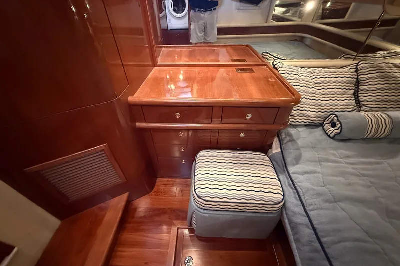 Slide: The Image of Luxurious 2002 Sea Ray 560 Sedan Bridge cabin with elegant wood finish and cozy bedding. - 83
