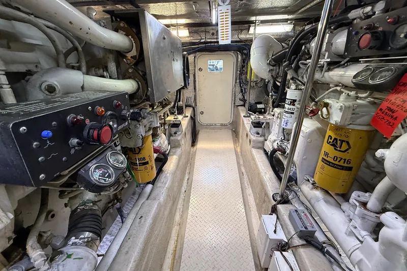Slide: The Image of Engine room of a 2002 Sea Ray 560 Sedan Bridge yacht, showcasing machinery and controls. - 128