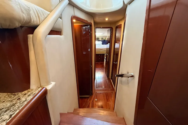 Slide: The Image of Interior view of 2002 Sea Ray 560 Sedan Bridge yacht, featuring elegant wood finishes and cozy cabin. - 77