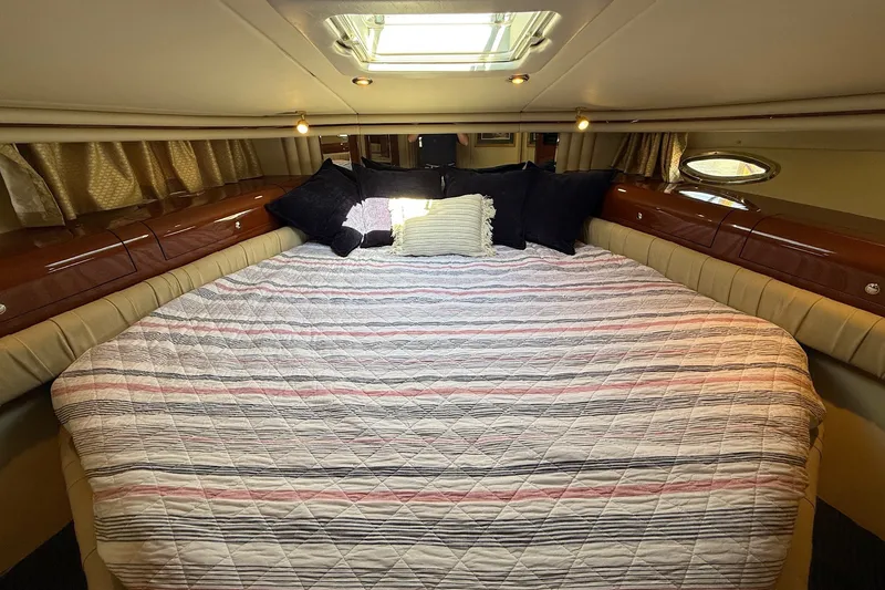 Slide: The Image of Luxurious 2002 Sea Ray 560 Sedan Bridge cabin with cozy bedding and elegant wood accents. - 98
