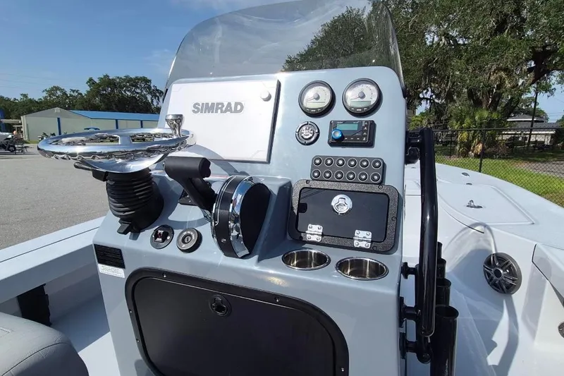 Slide: The Image of 2027 Blazer 675 Ultimate Bay boat dashboard with Simrad navigation system and controls. - 19