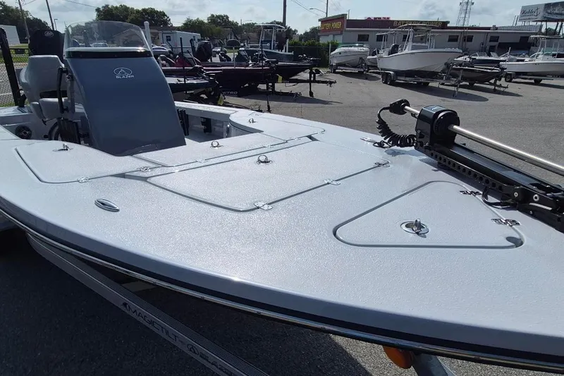 Slide: The Image of 2027 Blazer 675 Ultimate Bay boat displayed in a dealership lot. - 16